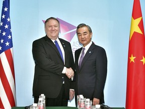 U.S. Secretary of State Mike Pompeo, left, and China's Foreign Minister Wang Yi pose for a photograph ahead of a bilateral meeting on the sidelines of the 51st ASEAN Foreign Ministers Meeting in Singapore, Friday, Aug. 3, 2018.