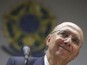 FILE - In this May 17, 2016 file photo, Brazil's Finance Minister Henrique Meirelles listens to a question during a press conference in Brasilia, Brazil. The party of outgoing Brazilian President Michel Temer has picked its own presidential candidate for the first time in 24 years. The Brazilian Democratic Movement on Thursday, Aug. 2, 2018, announced Meirelles as its candidate for the upcoming October election.