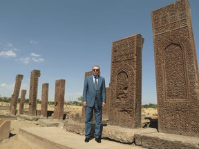 Turkey's President Recep Tayyip Erdogan poses for pictures during a visit at Ahlat, a historic area in Bitlis province, eastern Turkey, Sunday, Aug. 26, 2018.  Erdogan has agreed with Russian President Vladimir Putin, for increased cooperation in defense, energy and trade. (Presidential Press Service via AP, Pool)