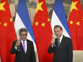 El Salvador's Foreign Minister Carlos Castaneda and China's Foreign Minister Wang Yi celebrate a toast at a signing ceremony to mark the establishment of diplomatic relations between El Salvador and China at the Diaoyutai State Guesthouse in Beijing, China, Tuesday, Aug. 21, 2018.