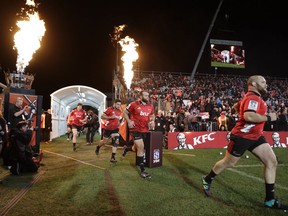 Crusaders players run out prior to the start of Super Rugby final against the Lions in Christchurch, New Zealand, Saturday, Aug. 4, 2018.
