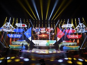 In this Sunday Aug. 26, 2018 photo, the China eSports team play Taiwan in the eSports exhibition at the 18th Asian Games Arena of Valor, Britama Arena, Jakarta. Esports is debuting as an exhibition sport in the on-going Asian Games and is targeted for full inclusion in four years at the games in Hangzhou, China.