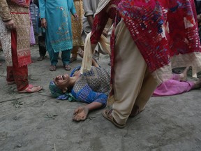 A Kashmiri woman cries during the funeral of her son, slain policeman Adil Ahmad, at Zaura village, about 62 kilometers south of Srinagar, Indian controlled Kashmir, Wednesday, Aug. 29, 2018. Rebels fighting against Indian rule ambushed a group of police officers and killed four of them, including Ahmad, on Wednesday in the disputed Himalayan region of Kashmir, police said.