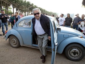 FILE - In this Oct. 26, 2014 file photo, Uruguay's former President Jose Mujica arrives to cast his vote in Montevideo, Uruguay. Mujica resigned on Tuesday, Aug. 14, 2018, from the senator's bench he won in the 2014 elections and in which he had the right to remain until March 2020.