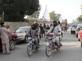 FILE -  In this June 16, 2018 file photo, Taliban fighters ride their motorbikes inside Ghazni city, capital of Ghazni province, west of Kabul, Afghanistan. An Afghan official said Sunday, Aug. 12, 2018, that security forces are battling the Taliban for the third straight day following a massive insurgent attack into the key city of Ghazni. The Taliban pushed into Ghazni from different directions on Friday and destroyed a telecommunication tower, cutting off landline and cell phone communications. (AP Photo, File)