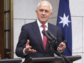 Australian Prime Minister Malcolm Turnbull address reporters at Parliament House in Canberra, Australia, Tuesday, Aug. 21, 2018. Turnbull called on his government to unite behind him after he survived a leadership challenge, defeating a senior minister in an internal ballot that is unlikely to settle questions of his support.