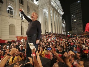 FILE - In this Match 28, 2018 file photo, Brazil's former President Luiz Inacio Lula da Silva stands amid supporters during the final rally of his week-long campaign tour of southern Brazil, in Curitiba, Parana state, Brazil. Da Silva leads preference polls for October's presidential election despite serving a 12-year-sentence for corruption.