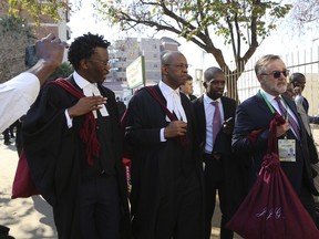 Lawyers representing the opposition party in Zimbabwe are seen upon arrival at the Constitutional Court in Harare, Wednesday, Aug, 22, 2018, to begin a challenge to the results of last months historic presidential election. The opposition claims the vote had "gross mathematical errors" and seeks a fresh election or a declaration of its candidate Nelson Chamisa as the winner of the July 30 vote.