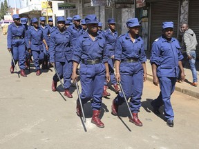 Zimbabwe police are seen on the streets of Harare, Zimbabwe, Thursday, Aug, 2, 2018.  Zimbabwe's acting President Emmerson Mnangagwa said Thursday that his government had been in touch with the main opposition leader in an attempt to ease tensions after election related violence in the capital.
