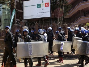 Police patrol outside the Zimbabwe Electoral Commission offices in Harare, Zimbabwe, Wednesday, Aug. 1, 2018.  Zimbabwe's ruling party has won a majority of seats in Parliament according to results announced Wednesday, but the results of the presidential vote have not yet been declared Thursday Aug. 2, 2018.