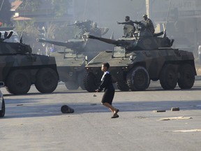 Military tanks patrol in Harare following demonstrations by opposition party supporters in the capital, Wednesday, Aug. 1, 2018. Gunfire, tear gas, and burning cars disrupted Harare's streets Wednesday as armed riot police and army troops clashed with rock-throwing opposition supporters, protesting delays in announcing the results of Monday's presidential election, the first after the fall of longtime leader Robert Mugabe.