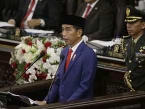 Indonesia's President Joko "Jokowi" Widodo delivers his state of the nation address ahead of the country's Independence Day at the parliament building in Jakarta, Indonesia, Thursday, Aug. 16, 2018. Jokowi urged his country to embrace its founding spirit of tolerance in an annual national address just days after choosing a divisive cleric as his running mate in elections next year.