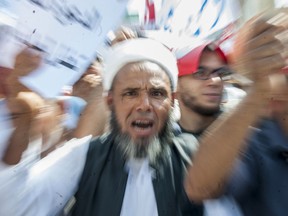 A man shouts during a demonstration in Tunis, Saturday Aug 11, 2018. Thousands of Muslim fundamentalists have held an hours-long protest in front of the nation's parliament to decry proposals in a government report on gender equality.