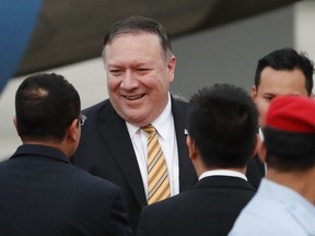 U.S. Secretary of State Michael Pompeo is greeted by local officials as he arrives at the military airport in Subang, outside of Kuala Lumpur, Malaysia, Thursday, Aug. 2, 2018. Pompeo will meet senior Malaysian officials to discuss strengthening the Comprehensive Partnership and advancing common security and economic interests.