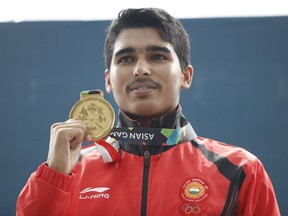 Gold medalist India's Saurabh Chaudhary, poses for photographers after the 10m air pistol men's final shooting event during the 18th Asian Games in Palembang, Indonesia, Tuesday, Aug. 21, 2018.