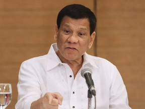 Philippine President Rodrigo Duterte gestures as he speaks during a press conference in Davao City, in the southern island of Mindanao on February 9, 2018. Human Rights Watch said President Rodrigo Duterte’s “admission should erase any doubt about the culpability of the president” and prod the International Criminal Court to hasten a review of a complaint against him for mass murder.