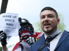 Jason Kessler (C), who organized the rally, speaks as white supremacists, neo-Nazis, members of the Ku Klux Klan and other hate groups gather for the Unite the Right rally in Lafayette Park across from the White House August 12, 2018 in Washington, DC.