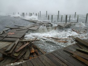 Portions of a boat dock and boardwalk are destroyed by powerful wind and waves as Hurricane Florence arrives September 13, 2018 in Atlantic Beach, United States.