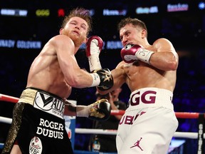 Gennady Golovkin, right, punches Canelo Alvarez during their WBC/WBA middleweight title fight at T-Mobile Arena on September 15, 2018 in Las Vegas, Nevada.