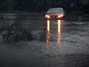 A car is stuck on a flooded street, on September 16, 2018 in Wilmington, North Carolina.