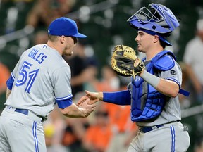 Ken Giles, left, celebrates with Toronto Blue Jays catcher Reese McGuire after a 6-4 victory against the Orioles in Baltimore on Tuesday night.