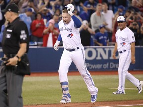 Justin Smoak of the Blue Jays celebrates after hitting a game-winning solo home run in the ninth inning against the Tampa Bay Rays on Thursday night at Rogers Centre in Toronto.