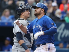 Rowdy Tellez of the Blue Jays celebrates after hitting a two-run homer in the fourth inning as Jesus Sucre of the Tampa Bay Rays looks on during their game Saturday at Rogers Centre in Toronto.