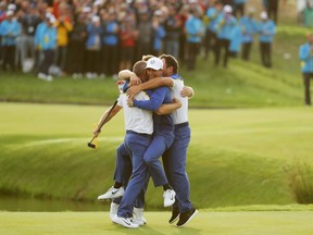 Alex Noren of Europe celebrates on the 18th green with team mates Thorbjorn Olesen, Tyrrell Hatton and Francesco Molinari of Europe as they win the Ryder Cup at Le Golf National on September 30, 2018 in Paris, France.
