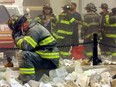 A firefighter breaks down after the World Trade Center buildings collapsed after two hijacked airplanes slammed into the twin towers in a terrorist attack September 11, 2001 in New York City.