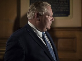 Ontario Premier Doug Ford arrives at his office the Ontario Legislature hold a midnight session to debate a bill that would cut the size of Toronto city council from 47 representatives to 25, in Toronto on Monday, September 17, 2018.