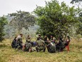 Members of the Revolutionary Armed Forces of Colombia (FARC), listen during a "class" on the peace process between the Colombian government and their force, at a camp in the Colombian mountains on February 18, 2016.