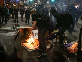 People protesting controversial Breitbart writer Milo Yiannopoulos burn trash and cardboard in the street on February 1, 2017 in Berkeley, California.