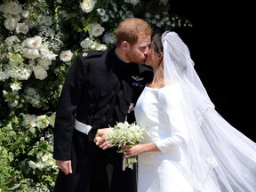 Britain's Prince Harry, Duke of Sussex kisses his wife Meghan, Duchess of Sussex as they leave from the West Door of St George's Chapel, Windsor Castle, in Windsor, on May 19, 2018 after their wedding ceremony. / AFP PHOTO / POOL / Andrew MatthewsANDREW MATTHEWS/AFP/Getty Images