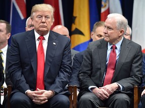 In this file photo taken on December 15, 2017 US President Donald Trump (L) sits with Attorney General Jeff Sessions in Quantico, Virginia, before participating in the FBI National Academy graduation ceremony.