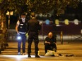 French police investigating on the scene where a man attacked and injured people with a knife in the streets of Paris in the 19th arrondissement on September 9, 2018.