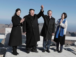 TOPSHOT - North Korean leader Kim Jong Un (second left) and his wife Ri Sol Ju (left) pose with South Korean President Moon Jae-in and his wife Kim Jung-sook on the top of Mount Paektu on September 20, 2018.