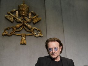U2 rock band frontman Bono Vox arrives for a press conference he held at the end of a meeting with Pope Francis, at the Vatican, Wednesday, Sept. 19, 2018.