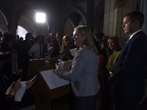 Leader of the Opposition Andrew Scheer (right) looks on as Leona Alleslev, who crossed the floor from the Liberal party to Conservative party speaks with the media about her decision on Parliament Hill in Ottawa, Monday September 17, 2018.
