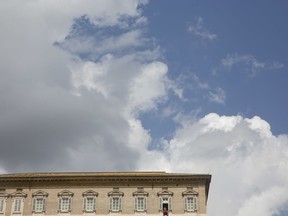 Clouds pass over the Apostolic palace as Pope Francis recites the Angelus noon prayer from the window of his studio overlooking St.Peter's Square, at the Vatican, Sunday, Sept. 2, 2018.