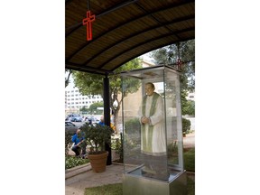 A statue in memory of father Pino Puglisi, slain by Mafia, is seen in front of his former home now museum in Palermo, Italy, Friday, Sept. 14, 2018. Pope Francis visits Sicily on Saturday to pay tribute to an Italian priest who was slain by the Mafia for his efforts to distance young people from organized crime.