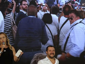 Italian Interior minister Matteo Salvini, right, is welcomed by Georgia Meloni, Brothers of Italy party's leader, at the party's event meeting in Rome, Saturday, Sept. 22, 2018.