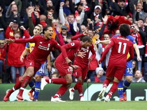Liverpool's Joel Matip, centre, celebrates scoring his side's second goal of the game, during the English Premier League soccer match between Liverpool and Southampton, at Anfield, in Liverpool, England, Saturday, Sept. 22, 2018.