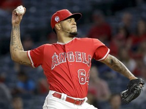 Los Angeles Angels relief pitcher Felix Pena throws against the Texas Rangers during the first inning of a baseball game in Anaheim, Calif., Wednesday, Sept. 12, 2018.