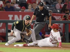 Los Angeles Angels' Shohei Ohtani, right, of Japan, steals third as Oakland Athletics third baseman Matt Chapman takes a late throw from home during the second inning of a baseball game Friday, Sept. 28, 2018, in Anaheim, Calif.