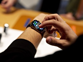 A customer uses an Apple Inc. Watch Series 4 smartwatch during a sales launch at a store in Chicago, Illinois, U.S., on Friday, Sept. 21, 2018.