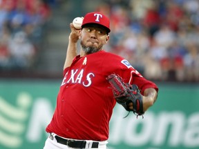 Texas Rangers starting pitcher Yovani Gallardo (49) pitches against the Minnesota Twins during the first inning of a baseball game, Saturday, Sept. 1, 2018, in Arlington, Texas.
