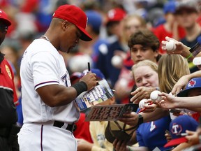 Texas Rangers' Adrian Beltre gives autographs to fans before his team's baseball game against the Seattle Mariners, Sunday, Sept. 23, 2018, in Arlington, Texas.