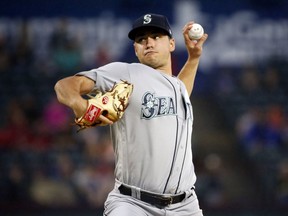 Seattle Mariners starting pitcher Marco Gonzales (32) pitches against the Texas Rangers during the first inning of a baseball game Saturday, Sept. 22, 2018, in Arlington, Texas.