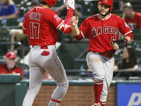 Los Angeles Angels' Shohei Ohtani (17) jumps in the air at home plate with David Fletcher (6) after hitting a two-run home run against the Texas Rangers during the eighth inning of a baseball game Wednesday, Sept. 5, 2018, in Arlington, Texas.