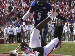 Arkansas receiver La' Michael Pettway makes a touchdown catch from his back in front of Eastern Illinois defender Iziah Gulley in the first half of an NCAA college football game Saturday, Sept. 1, 2018, in Fayetteville, Ark.